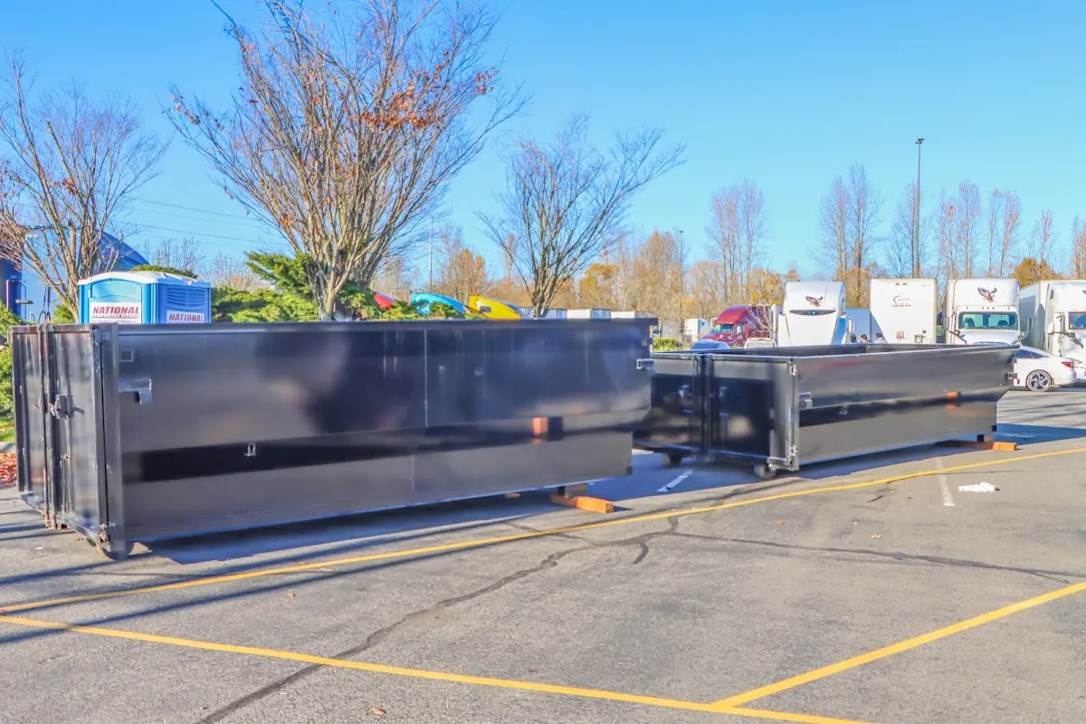 Professional dumpster rental service with roll-off container on residential driveway in Port Huron